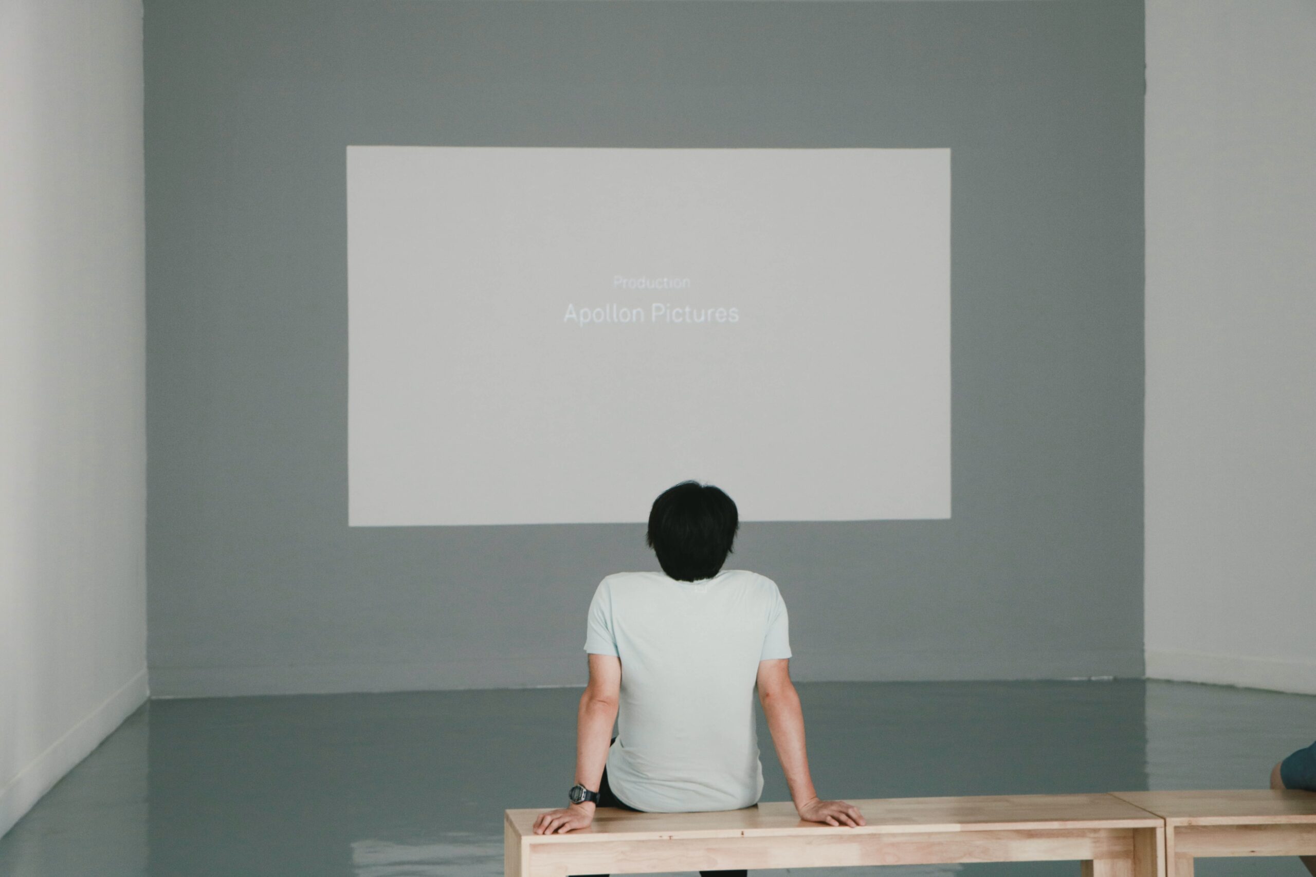 man watching video on gallery wall